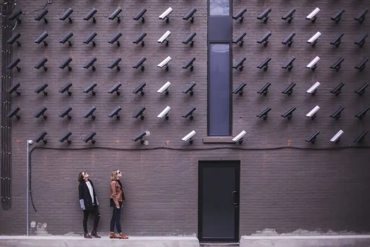 Cameras on Building Facing Two People