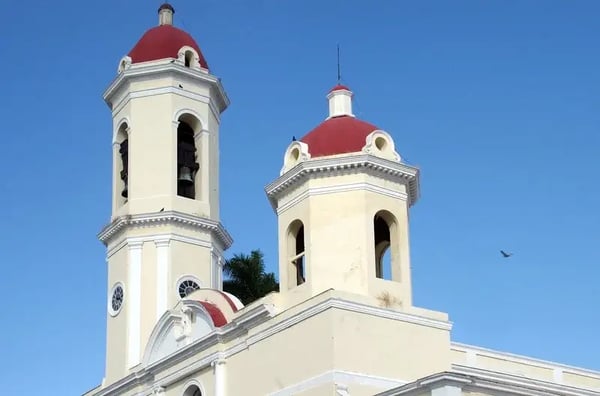 White cathedral with a red roof against a clear sky