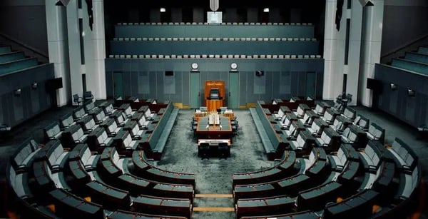 Empty hall of administrative building with empty seats and table in centre