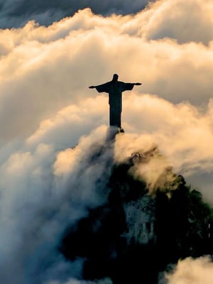 Large statue of Jesus in Brazil surrounded by clouds