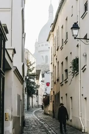 Man going on an old little street in France