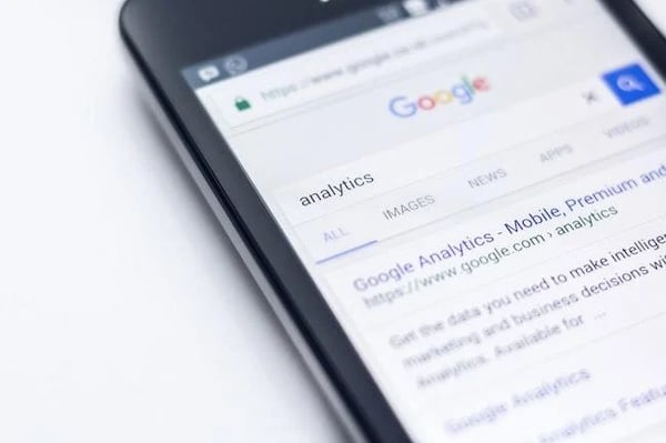 Mobile screen with searching Analytics in Google search