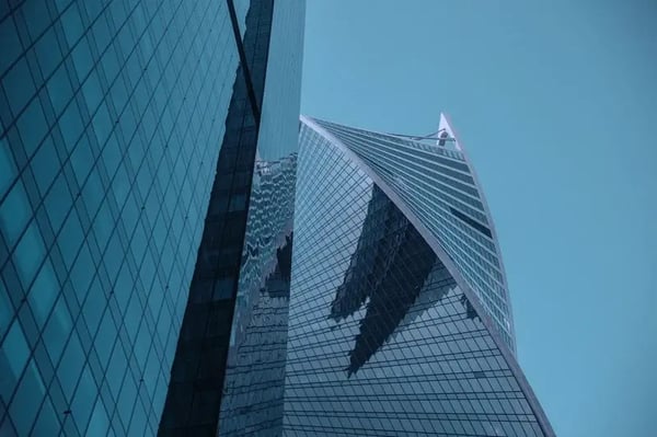 Modern skyscraper made of glass against the background of clear sky