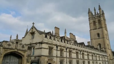 One of the buildings of Oxford against the background of cloudy blue sky