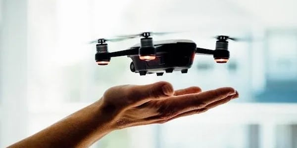Drone flying above humans hand